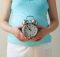 kika5026640_Pregnant-woman-holding-clock-e1553078007236